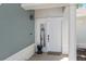 Close-up of the front door with a white frame, elegant columns, and a 'Welcome' mat on the tiled porch at 7636 Heritage Crossing Way, Reunion, FL 34747