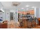 Spacious kitchen with a granite island, seating, stainless steel appliances, and an adjacent laundry room at 7636 Heritage Crossing Way, Reunion, FL 34747
