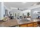 Open kitchen with granite countertops, stainless steel sink, and a view into the living and dining areas at 7636 Heritage Crossing Way, Reunion, FL 34747