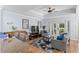 Comfortable living room with a tray ceiling, ceiling fan, French doors to the backyard, and stylish furnishings at 7636 Heritage Crossing Way, Reunion, FL 34747