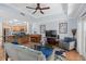 Open concept living room showcasing kitchen, breakfast bar, light blue walls, and hardwood floors at 7636 Heritage Crossing Way, Reunion, FL 34747