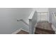 Gray stairs feature hardwood treads, white risers, and a safety gate at the top of the staircase at 7636 Heritage Crossing Way, Reunion, FL 34747