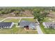 Aerial view of a gray home with a fenced yard and green lawn at 2155 Thompson Rd, Bartow, FL 33830