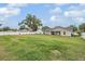 Large backyard featuring a well-maintained lawn, mature tree, and a white fence at 2155 Thompson Rd, Bartow, FL 33830