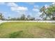 Large backyard surrounded by a white fence and featuring a well-maintained lawn at 2155 Thompson Rd, Bartow, FL 33830