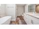 Luxurious bathroom with a soaking tub, double vanity with granite countertop, and modern fixtures at 2155 Thompson Rd, Bartow, FL 33830