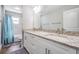 Bathroom featuring dual sinks with granite countertop, white cabinetry, and shower with blue curtain at 2155 Thompson Rd, Bartow, FL 33830
