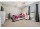 Bedroom with carpet, dresser, bedside table with a lamp, and a comfortable bed at 2155 Thompson Rd, Bartow, FL 33830