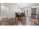 Cozy dining area featuring wood-look floors, a modern table, and bright natural light at 2155 Thompson Rd, Bartow, FL 33830