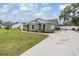 Single-story home with landscaped front yard, long driveway, and white fence at 2155 Thompson Rd, Bartow, FL 33830
