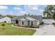 Charming single-story home with a gray stucco exterior, green lawn and landscaped walkway at 2155 Thompson Rd, Bartow, FL 33830