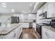 Sleek kitchen featuring stainless steel appliances, modern lighting, and white cabinets at 2155 Thompson Rd, Bartow, FL 33830