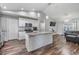 Bright, open kitchen features white cabinets, granite countertops, pendant lighting and an island with seating at 2155 Thompson Rd, Bartow, FL 33830
