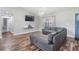 Comfortable living room featuring a large sectional sofa, stylish wood-look flooring, and a modern ceiling fan at 2155 Thompson Rd, Bartow, FL 33830