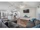 Open concept living area with wood-look floors, modern furniture, and a ceiling fan for comfortable living at 2155 Thompson Rd, Bartow, FL 33830
