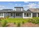 Back exterior of a house with a covered patio and manicured lawn at 6615 Quest St, St Cloud, FL 34771