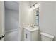 Modern bathroom features a white vanity with sleek black hardware and a rectangular mirror at 6615 Quest St, St Cloud, FL 34771