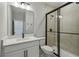 Modern bathroom features a white vanity with a glass shower and neutral tiling at 6615 Quest St, St Cloud, FL 34771