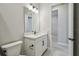 Bright bathroom with a modern vanity, neutral tile flooring and an open doorway at 6615 Quest St, St Cloud, FL 34771