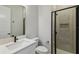 Modern bathroom with sleek vanity, toilet, and a glass-enclosed tiled shower for a luxurious experience at 6615 Quest St, St Cloud, FL 34771