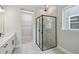 Modern bathroom featuring glass shower and a walk-in closet space at 6615 Quest St, St Cloud, FL 34771