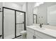 Modern bathroom features a glass enclosed shower and white vanity for a clean and refreshing space at 6615 Quest St, St Cloud, FL 34771