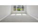 Bright bedroom featuring carpet and large windows with natural light at 6615 Quest St, St Cloud, FL 34771