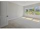 Well lit bedroom with neutral carpet and large windows with natural light at 6615 Quest St, St Cloud, FL 34771