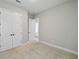 Bedroom featuring carpeted floors, double closets and a connecting doorway to the rest of the home at 6615 Quest St, St Cloud, FL 34771