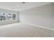 Bright, carpeted bedroom with three large windows for plenty of natural light at 6615 Quest St, St Cloud, FL 34771