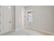 Cozy bedroom features neutral carpet, white trim and a window for natural light at 6615 Quest St, St Cloud, FL 34771
