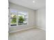 Bright bedroom with plush carpeting and a large window offering neighborhood views at 6615 Quest St, St Cloud, FL 34771