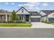 Charming home with gray trim, stone accents, a well-manicured lawn, and an attached two-car garage at 6615 Quest St, St Cloud, FL 34771