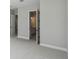 Open hallway leading to a bath, featuring neutral walls, white doors, and carpet floors at 6615 Quest St, St Cloud, FL 34771