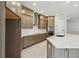 A kitchen is featuring custom cabinets, stainless appliances, and a center island with quartz countertop and tile backsplash at 6615 Quest St, St Cloud, FL 34771