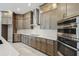 Custom kitchen featuring stainless appliances, stone countertops, designer backsplash, and custom cabinets at 6615 Quest St, St Cloud, FL 34771