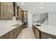 The kitchen is featuring stainless appliances, custom cabinets, and a large center island with quartz countertops at 6615 Quest St, St Cloud, FL 34771