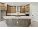Kitchen featuring custom cabinets, stainless appliances, quartz countertops, and a center island at 6615 Quest St, St Cloud, FL 34771