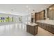 Open living space with a modern kitchen, large island, and great natural light from many windows at 6615 Quest St, St Cloud, FL 34771