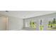 Light, bright living space featuring multiple windows and an exit door to the backyard at 6615 Quest St, St Cloud, FL 34771