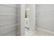 Spacious walk-in closet features wire shelving for organized storage with a view into an ensuite bathroom at 6615 Quest St, St Cloud, FL 34771