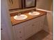 A bathroom with a double sink vanity with a granite countertop with white cabinets at 5118 Log Wagon Rd, Ocoee, FL 34761