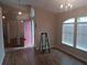 Welcoming entryway featuring wood floors and a view into the home with an open door and a chandelier at 5118 Log Wagon Rd, Ocoee, FL 34761