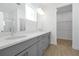 Modern bathroom with double vanity, quartz countertops, and a glass-enclosed shower at 5774 Greenery Ln, St Cloud, FL 34771