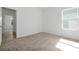 Bright, carpeted bedroom with a window and an ensuite bathroom at 5774 Greenery Ln, St Cloud, FL 34771