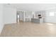 Open-concept kitchen with gray island, stainless steel appliances, and ceramic tile flooring at 5774 Greenery Ln, St Cloud, FL 34771