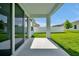 Covered patio overlooking a green backyard, ideal for outdoor relaxation and entertaining at 5774 Greenery Ln, St Cloud, FL 34771