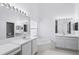 Bright bathroom with white vanities, large mirrors, and a soaking tub at 1372 Madison Ivy Cir, Apopka, FL 32712