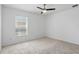 Carpeted bedroom with a ceiling fan and large window at 1372 Madison Ivy Cir, Apopka, FL 32712