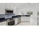 Well-equipped kitchen features stainless steel appliances, modern lighting, and a stylish backsplash at 1372 Madison Ivy Cir, Apopka, FL 32712